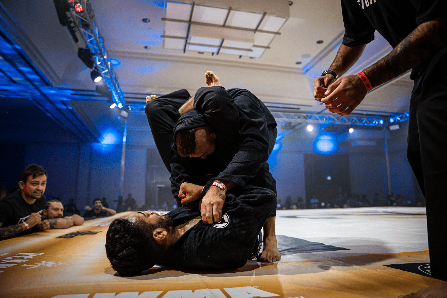 Dos luchadores de Brazilian Jiu-Jitsu practicando técnicas de grappling en el tatami."