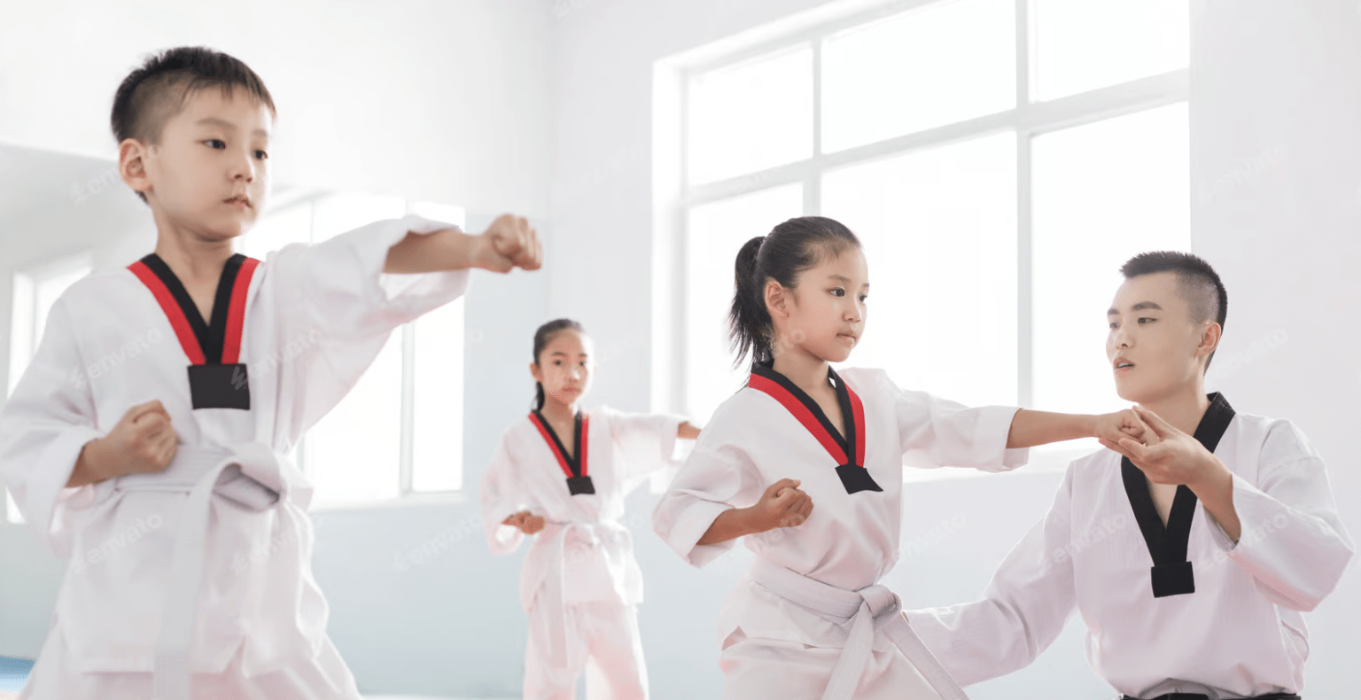 Clase de taekwondo para niños con instructor Profesor enseñando taekwondo a niños durante una clase de entrenamiento